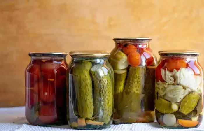 4 jars with an assortment of pickled veggies