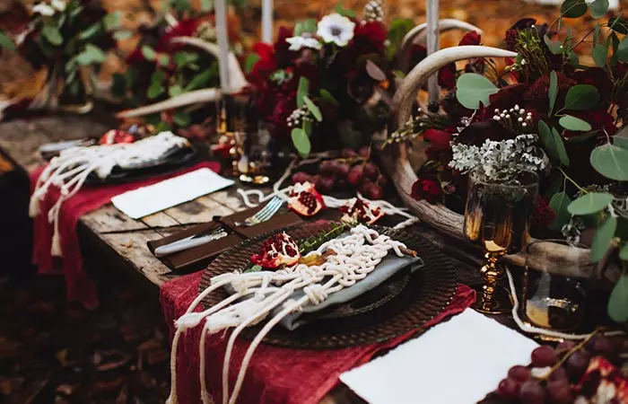 A table spread of fall decor and handmade favors for the guests at a fall wedding