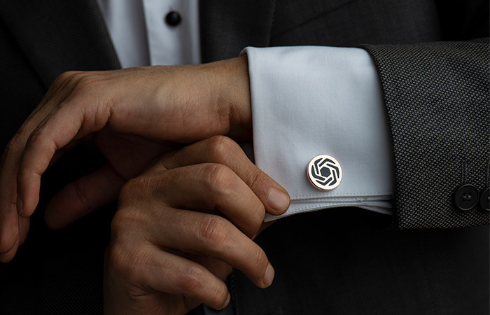 A closeup of a man showing how to wear cufflinks the right way