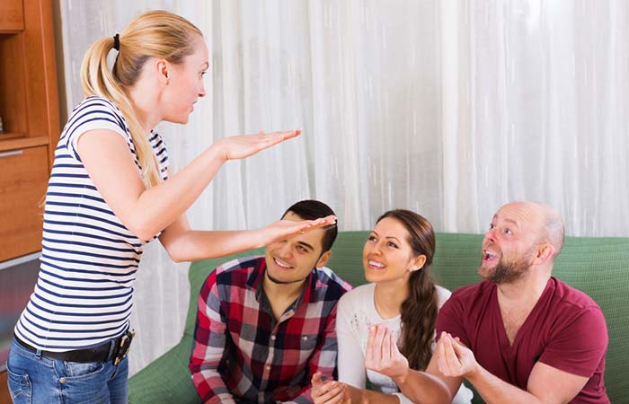 A group of friends playing charades at a house party