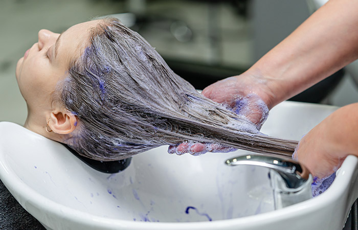 Woman taking a bleach bath to remove blue color