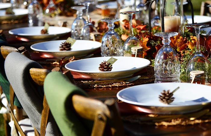 Fall-themed wedding tables decorated with autumnal accents 