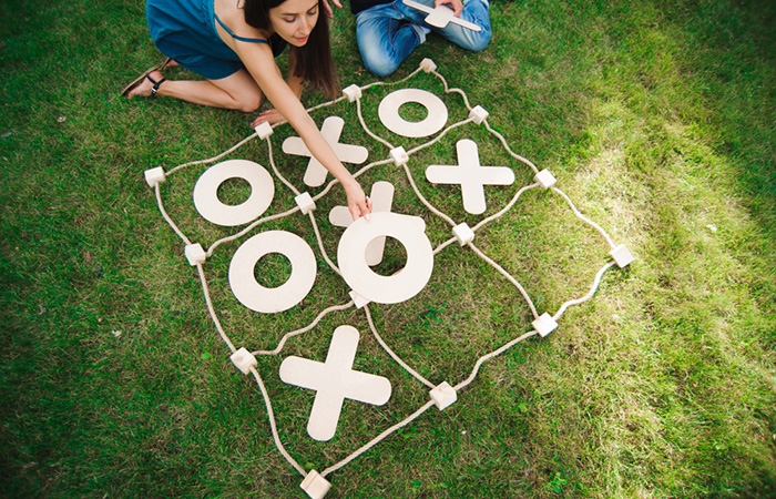 Friends playing a game of giant tic-tac-toe outside