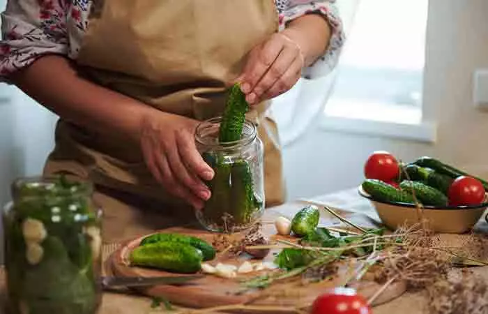 Woman makes pickes at home.