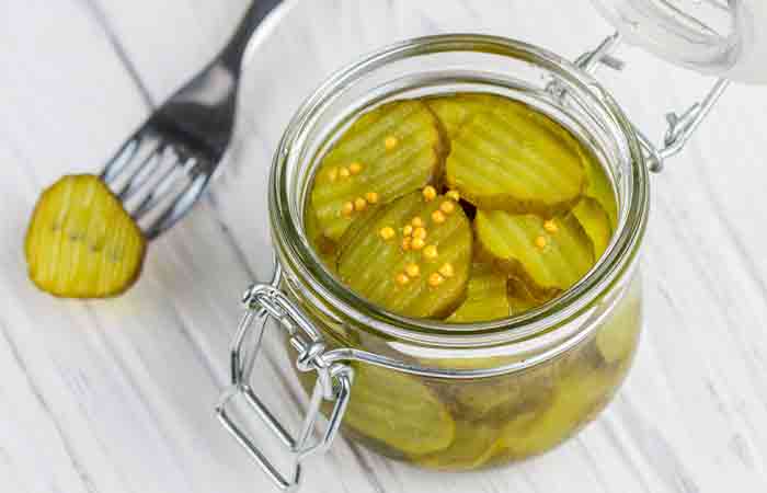 Top view of an open jar of sliced dill cucumber pickles
