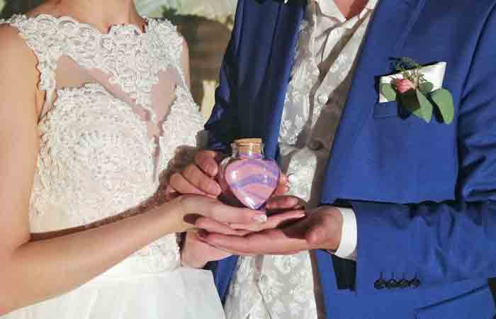 Wedded pair displaying jar from unity sand ceremony