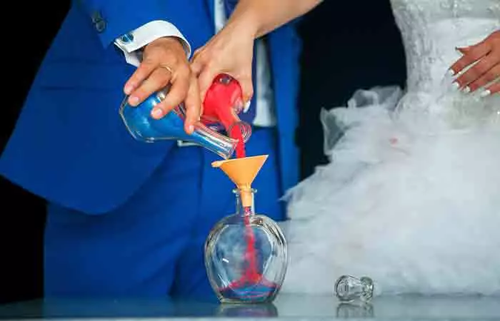 Bride and groom performing the unity sand ceremony