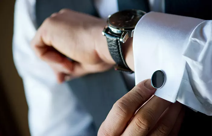 Closeup of cufflinks worn on a regular shirt