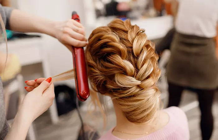 Model getting hair styled at a salon