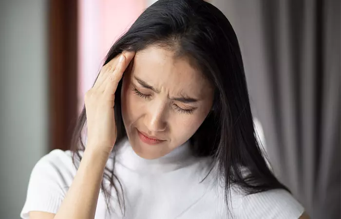 Woman feeling dizzy due to side effect of scallops