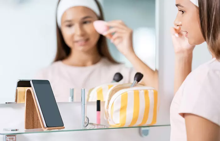 Girl doing simple prom makeup.