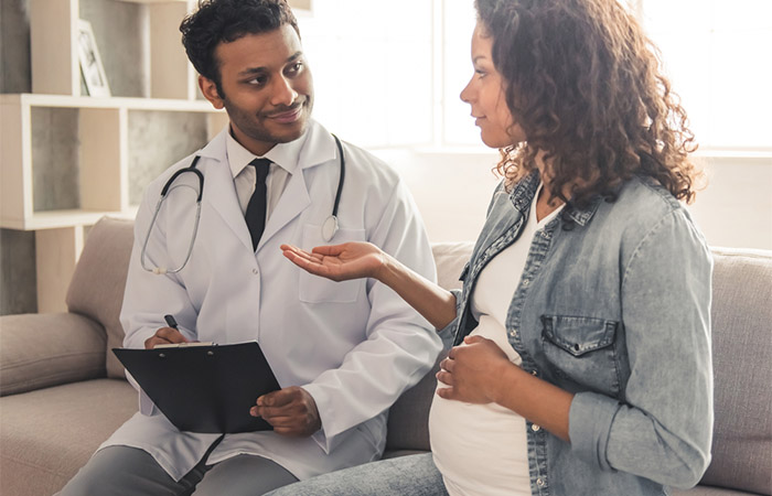 Pregnant woman consultating a doctor for cold