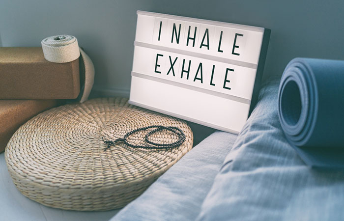 A placard with 'inhale, exhale' written on it