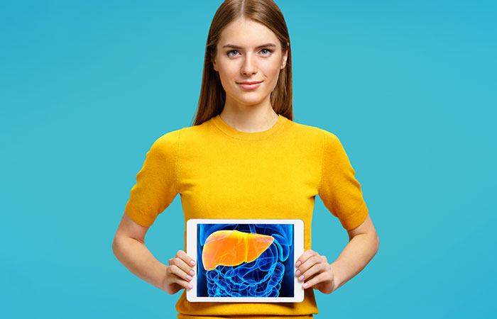 A woman holding the image of a liver.