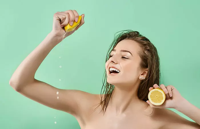 A woman juicing lemon for her hair