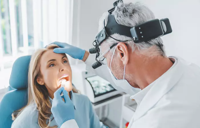 Doctor checking woman’s mouth for strep throat