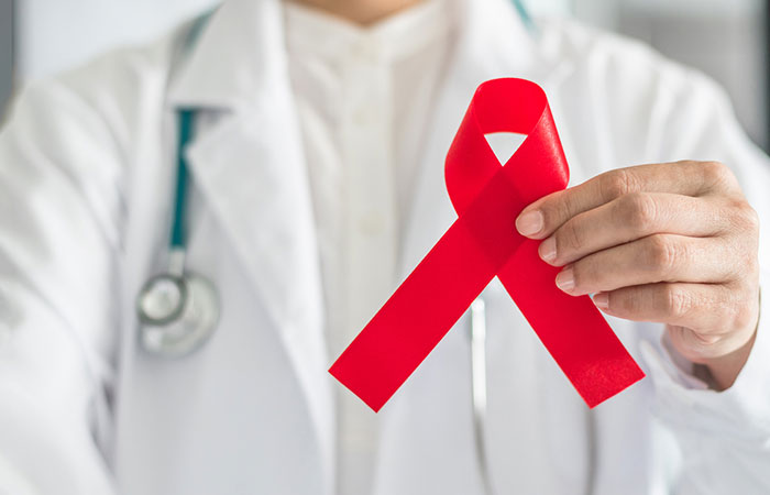 Doctor holding AIDS red ribbon