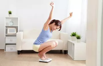 Excited woman as a result of weight loss.