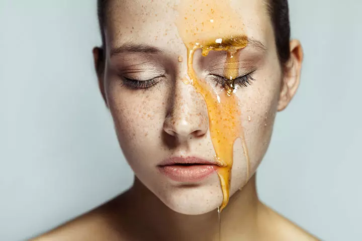 Honey dripping down a woman's face