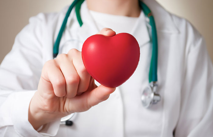Red heart in the hand of a physician