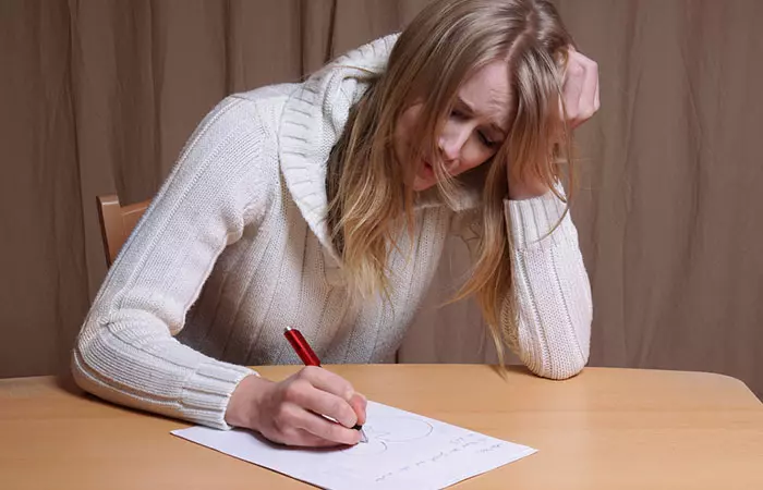 Upset woman writing apology letter