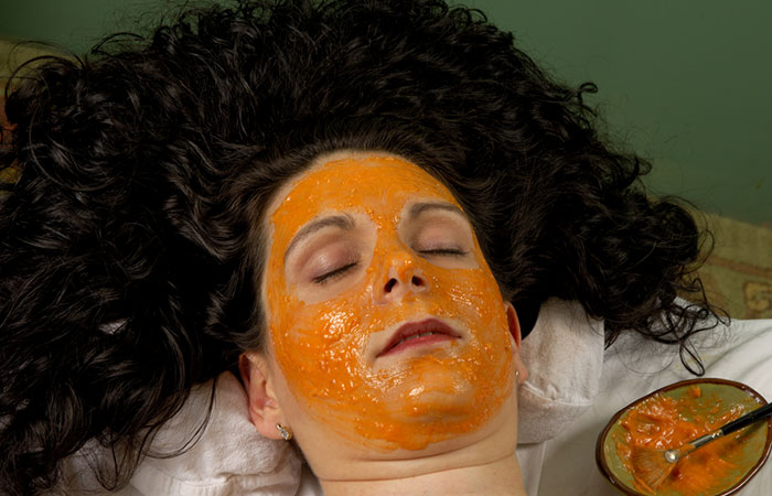 Woman applied orange face mask to rejuvenate her skin