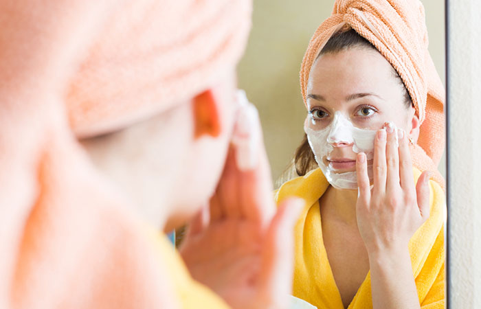 Woman applies yogurt face mask