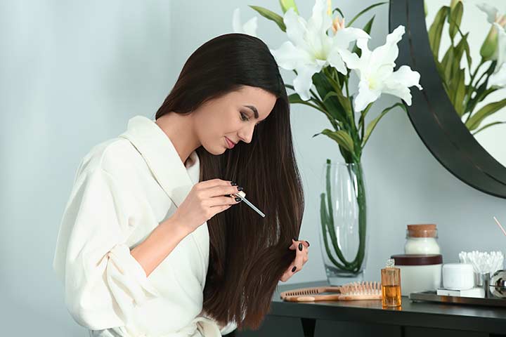 Woman applying camellia oil on scalp