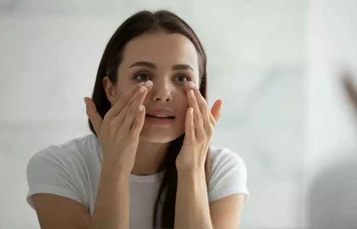 Woman applying eye cream