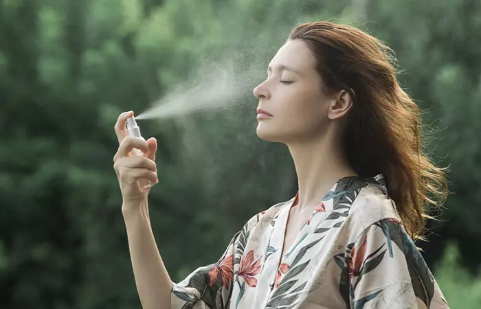 Woman applying facial mist