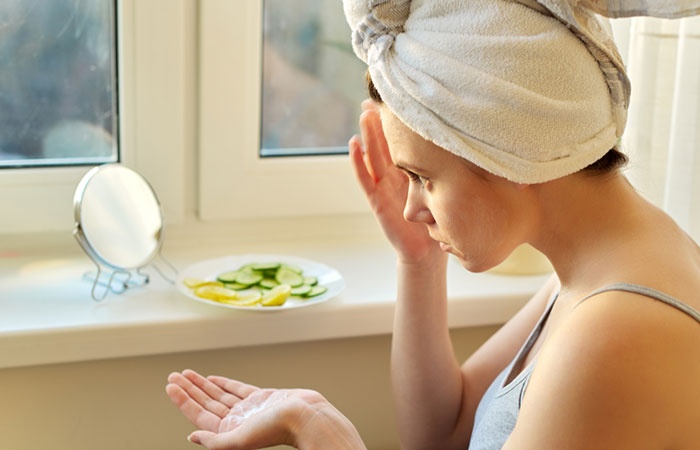 Woman applying lemon juice for acne and scarring