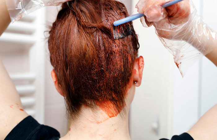 Woman applying vegetal hair dye