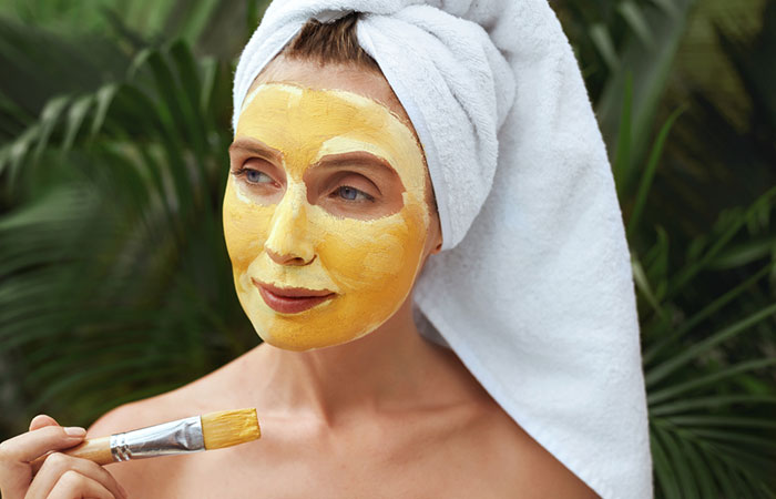 Woman appying a DIY pumpkin face mask 
