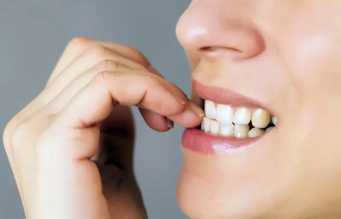 Woman biting nails