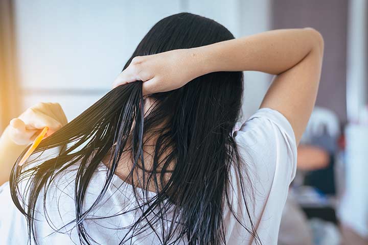 Woman brushing her hair after washing it daily