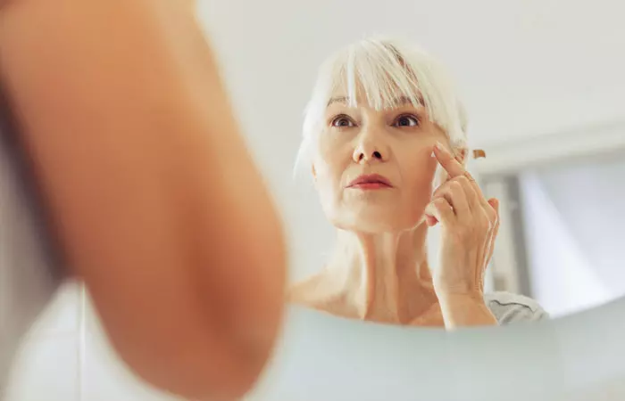 Woman checking signs on aging on her face