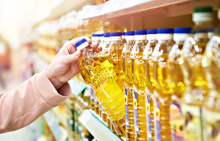 Woman checking sunflower oil at a store