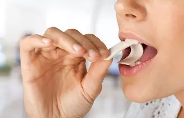 Woman chewing gum to get rid of popping ears
