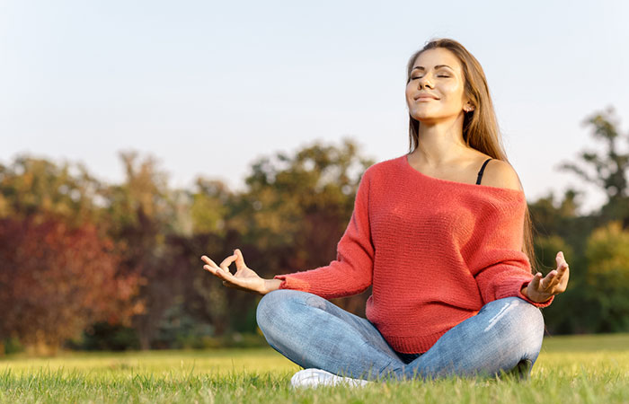 Woman closing her eyes while practicing tummo meditation