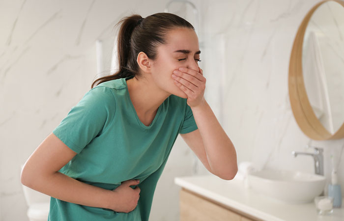 Woman experiencing nausea as a side-effect of clenbuterol