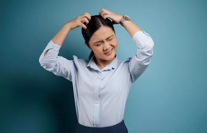 Woman experiencing scalp irritation after cellophane treatment