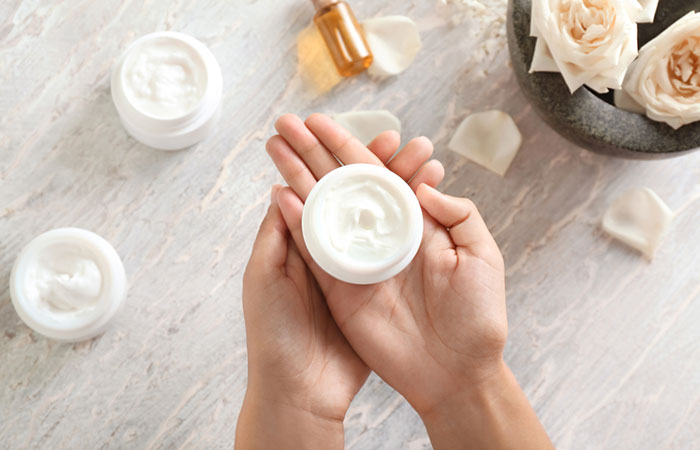 Woman holding a moisturizer with both hands