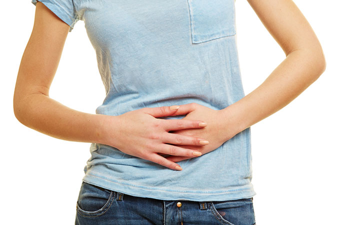 Woman holding stomach to show gut issues