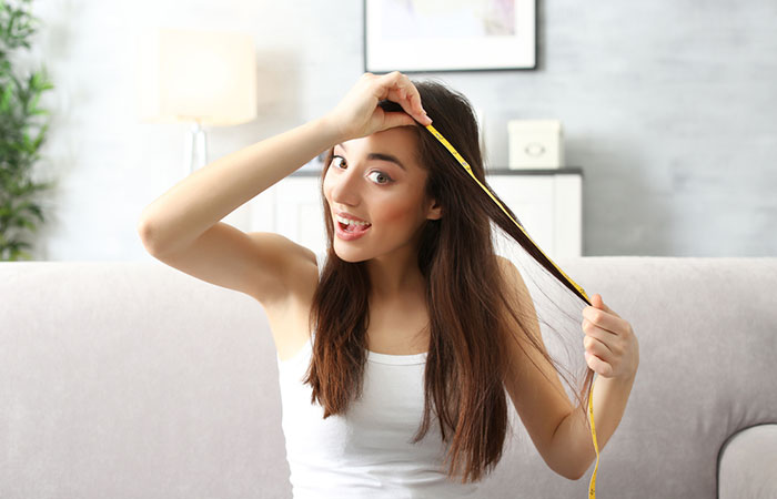 Woman measuring her hair length