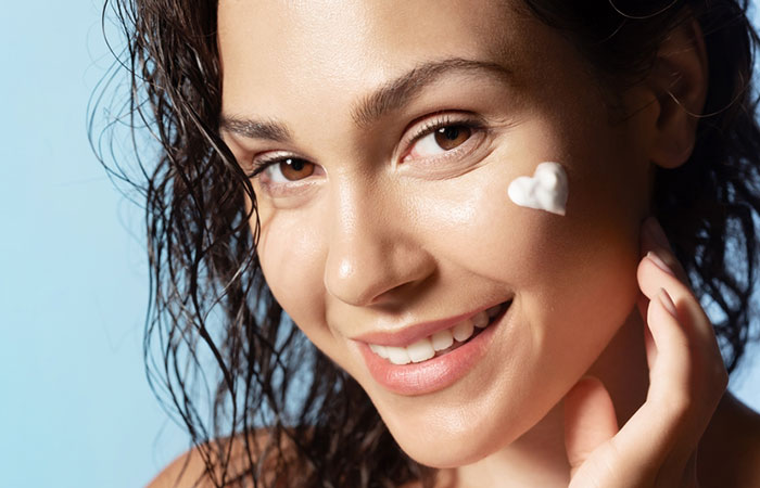 Woman moisturizing the skin to prevent skin peeling