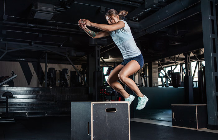 Woman practising box-jumping before jogging