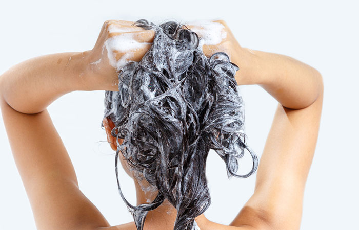 Woman shampooing hair with argan oil shampoo