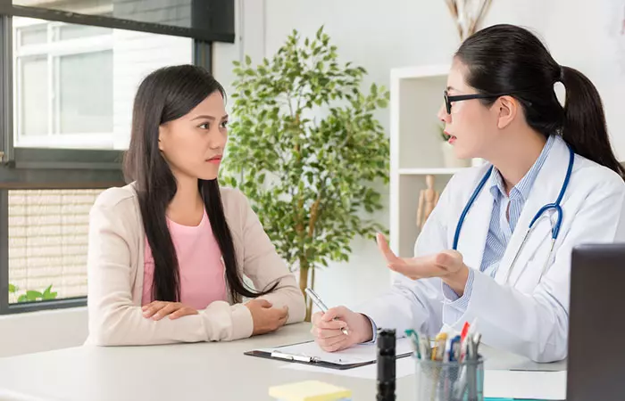 Woman speaking to dermatologist before using alpha arbutin for skin