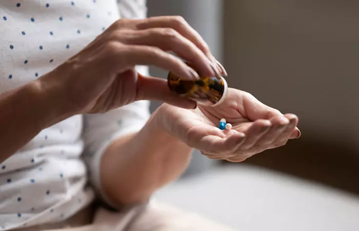 Woman taking vitamin supplements for genital warts