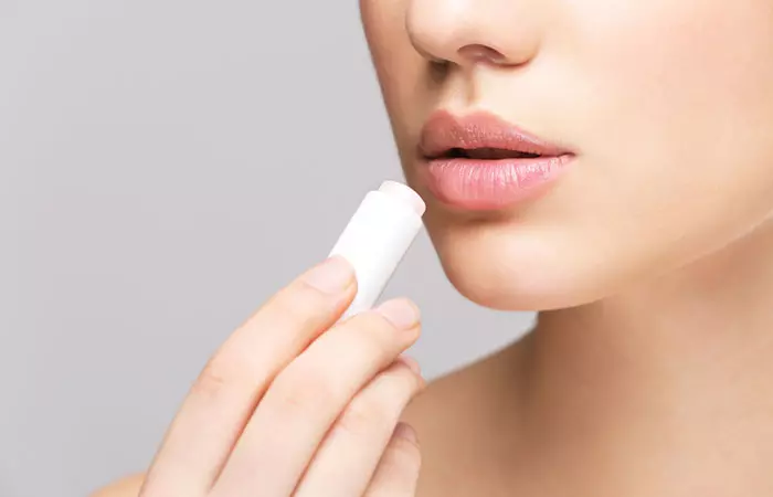 Woman using an aloe vera lip balm